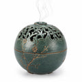Brûleur d'encens sphérique vert avec motifs floraux ajourés